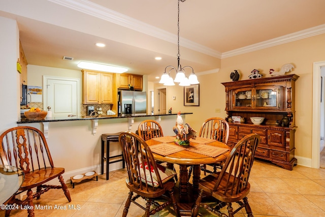 tiled dining area featuring ornamental molding and a chandelier