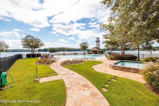 view of pool featuring a water view and a hot tub