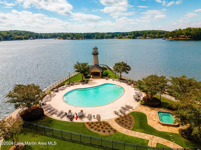 view of swimming pool featuring a water view