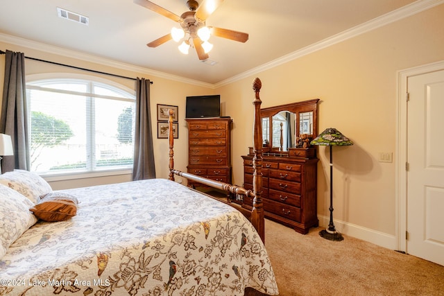 carpeted bedroom featuring ceiling fan and crown molding