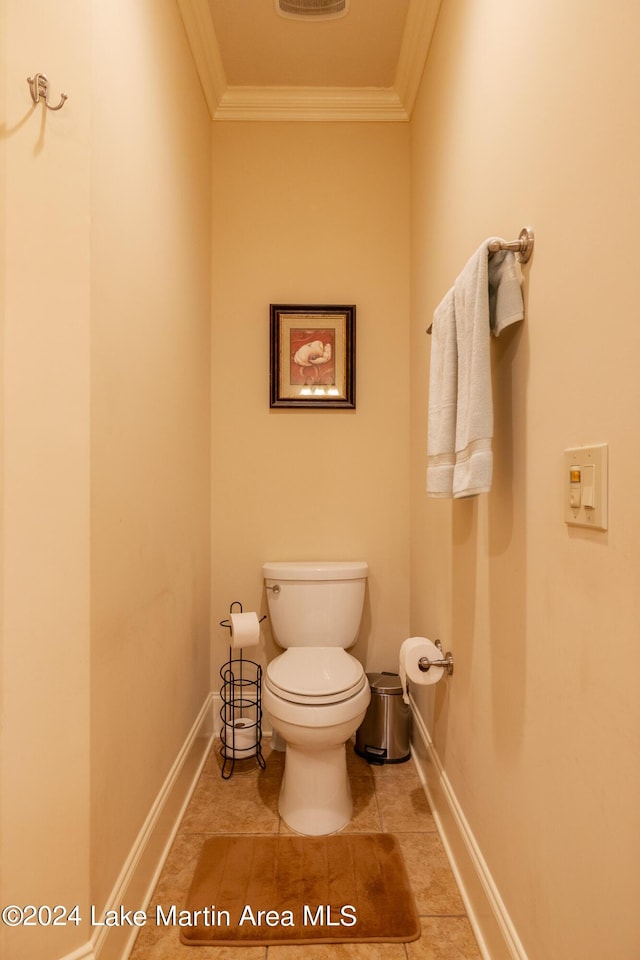 bathroom featuring toilet, tile patterned floors, and crown molding