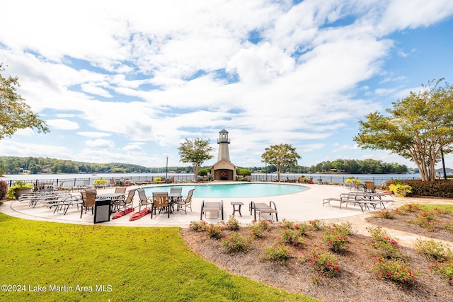 view of swimming pool featuring a patio area and a water view