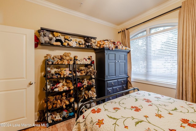 bedroom with wood-type flooring and ornamental molding