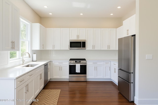 572 Newman Rd, Alexander City, AL 35010 - kitchen featuring stainless steel appliances, backsplash, white cabinets, light countertops, and dark wood-style floors