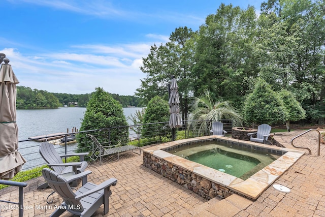 47 Oaks Knl, Jacksons Gap, AL 36861 - view of pool featuring an outdoor fire pit, a patio area, an in-ground hot tub, and a water view