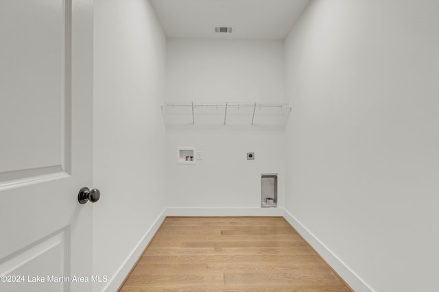 laundry room with hookup for a washing machine, light hardwood / wood-style floors, and hookup for an electric dryer