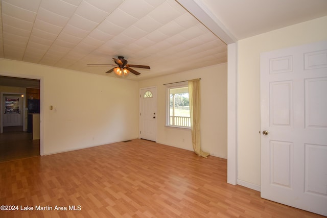 empty room with ceiling fan and light hardwood / wood-style flooring