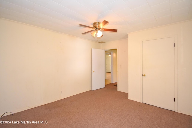 unfurnished bedroom with ceiling fan and light carpet