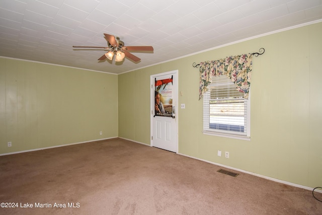 carpeted empty room with ceiling fan and crown molding