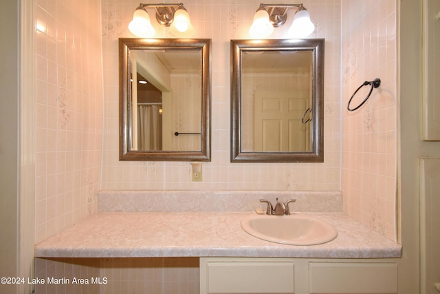 bathroom featuring vanity, tile walls, and backsplash