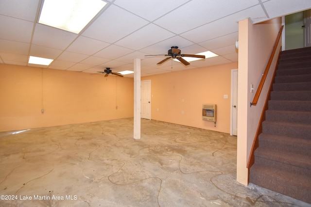 basement with heating unit, ceiling fan, and a paneled ceiling