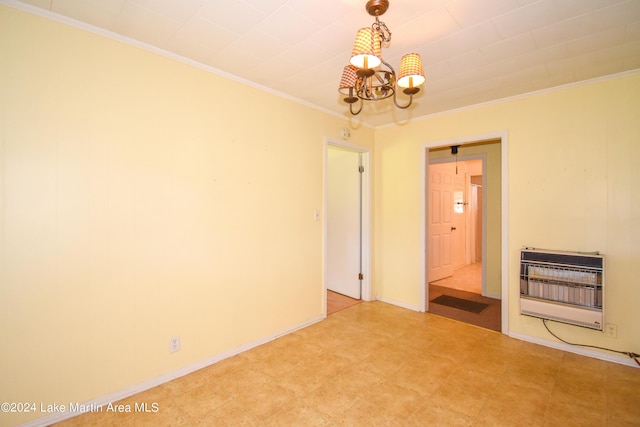 empty room with a notable chandelier, crown molding, and heating unit