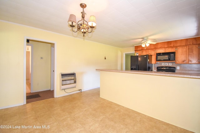 kitchen featuring ceiling fan with notable chandelier, heating unit, crown molding, black appliances, and decorative light fixtures