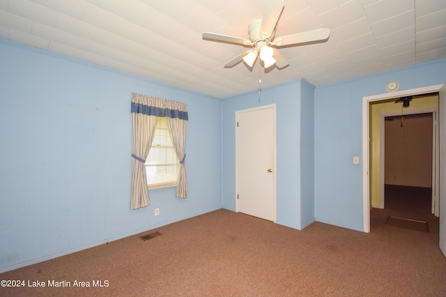 carpeted empty room featuring ceiling fan and ornamental molding