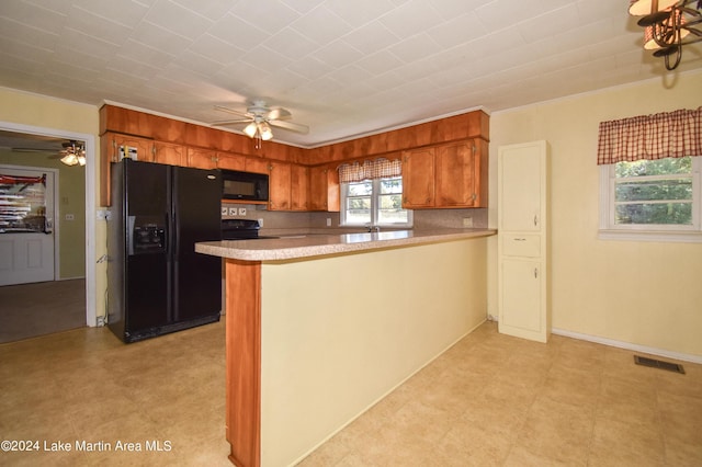 kitchen featuring backsplash, kitchen peninsula, ceiling fan, and black appliances