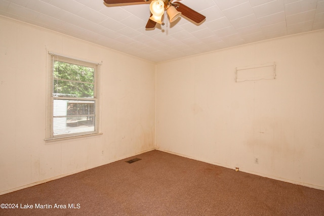 empty room featuring carpet flooring, ceiling fan, and ornamental molding