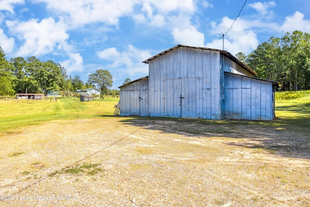 view of outbuilding featuring a yard