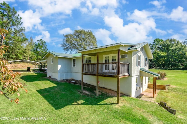 back of property featuring a carport and a lawn