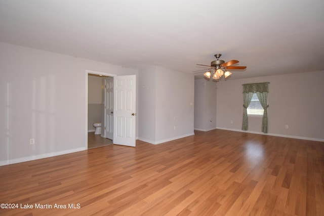 spare room with ceiling fan and light wood-type flooring