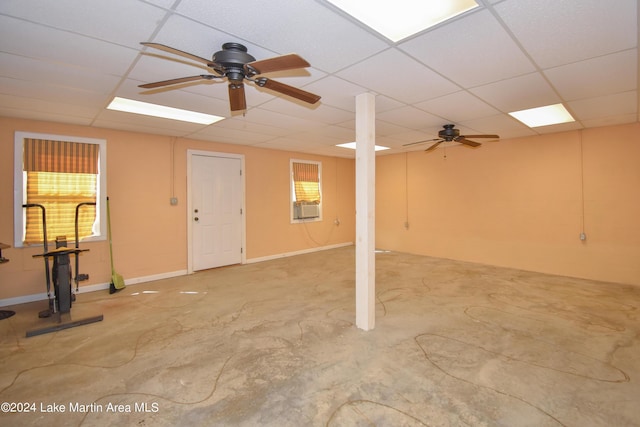 basement featuring a drop ceiling and ceiling fan