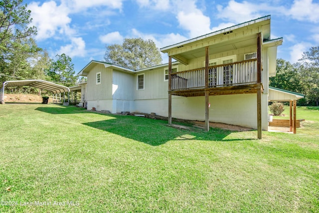 rear view of house featuring a carport and a lawn