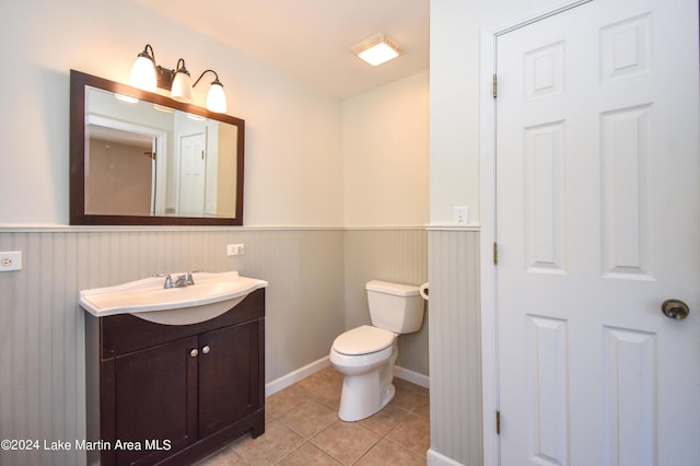 bathroom featuring tile patterned floors, vanity, and toilet