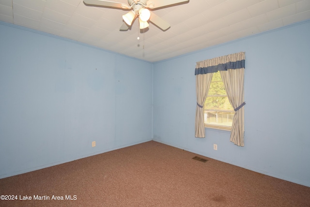 carpeted empty room featuring ceiling fan and crown molding