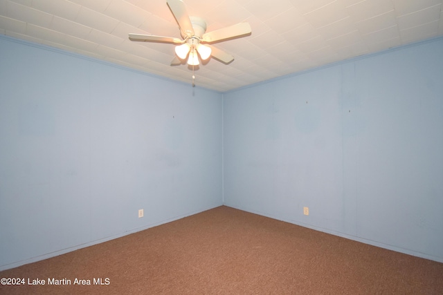 spare room with crown molding, carpet floors, and ceiling fan