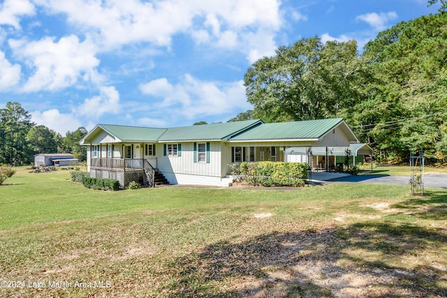 view of front of house with a carport, covered porch, and a front yard