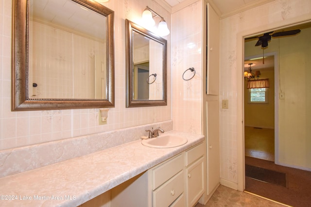 bathroom with crown molding, vanity, tile walls, and ceiling fan