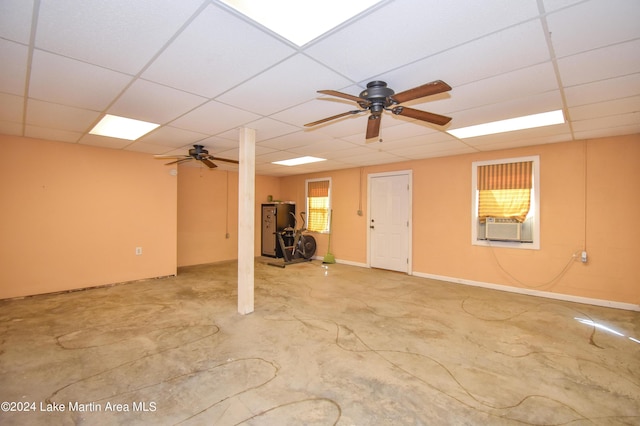 basement with a drop ceiling and ceiling fan