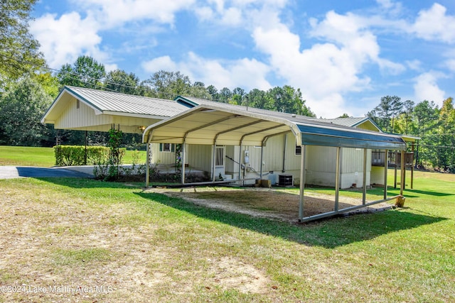 view of car parking with a carport and a lawn