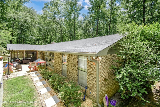 514 Sleepy Holw, Alexander City, AL 35010 - back of house with a patio area, a shingled roof, and brick siding