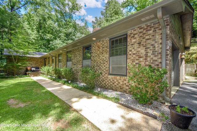 514 Sleepy Holw, Alexander City, AL 35010 - view of home's exterior with brick siding, a yard, and a chimney