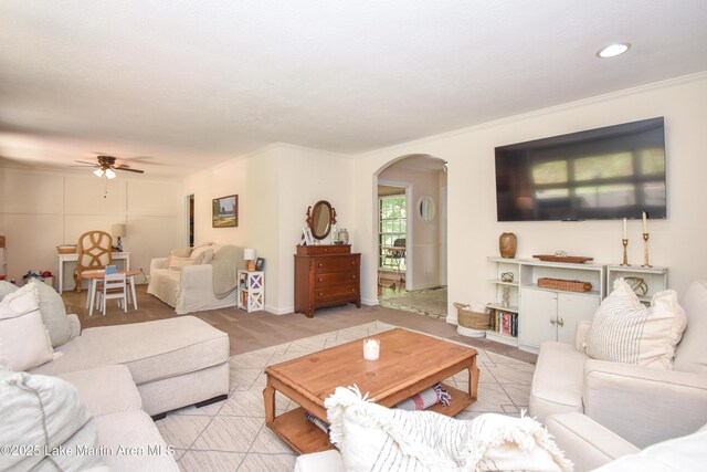 514 Sleepy Holw, Alexander City, AL 35010 - living room with arched walkways, ceiling fan, light colored carpet, and crown molding