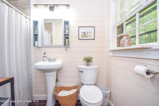 514 Sleepy Holw, Alexander City, AL 35010 - bathroom featuring wood walls and a shower with shower curtain