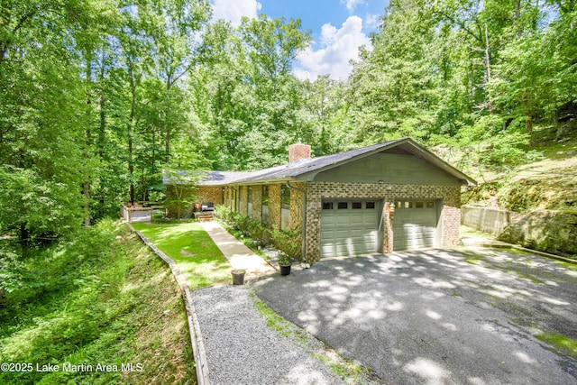 514 Sleepy Holw, Alexander City, AL 35010 - view of front facade featuring brick siding, a chimney, asphalt driveway, and a garage