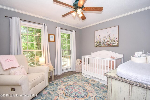 514 Sleepy Holw, Alexander City, AL 35010 - bedroom with a crib, crown molding, wood finished floors, and ceiling fan