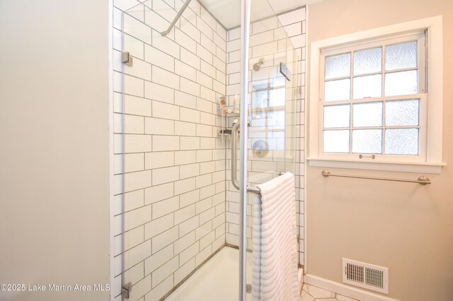 bathroom with a shower with door