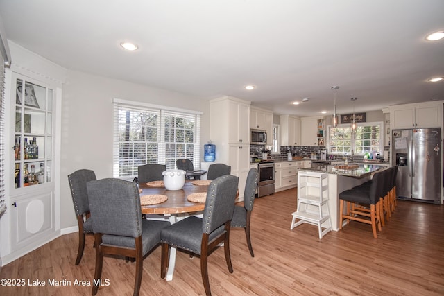 dining room featuring plenty of natural light and light wood-type flooring