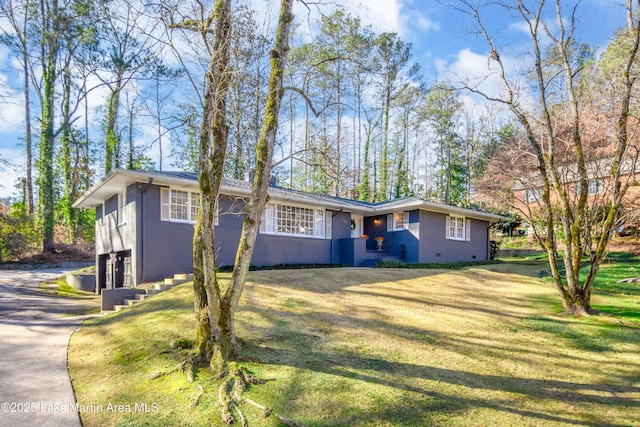 view of front of house with a front yard and a garage