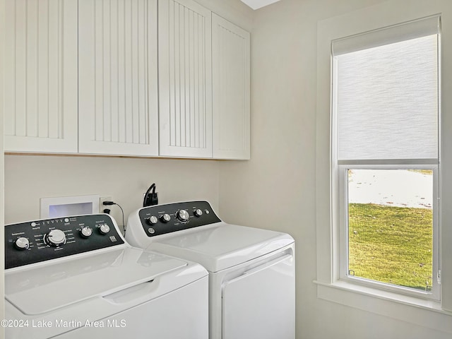 laundry area featuring cabinets and separate washer and dryer