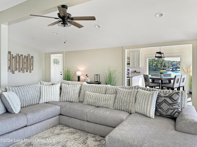 living room featuring vaulted ceiling and ceiling fan