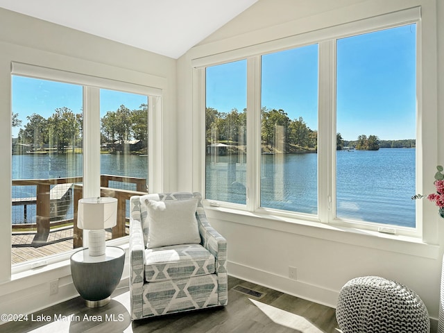 sunroom / solarium featuring a healthy amount of sunlight and a water view