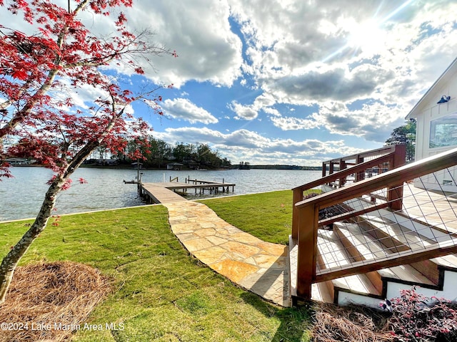 dock area featuring a lawn and a water view