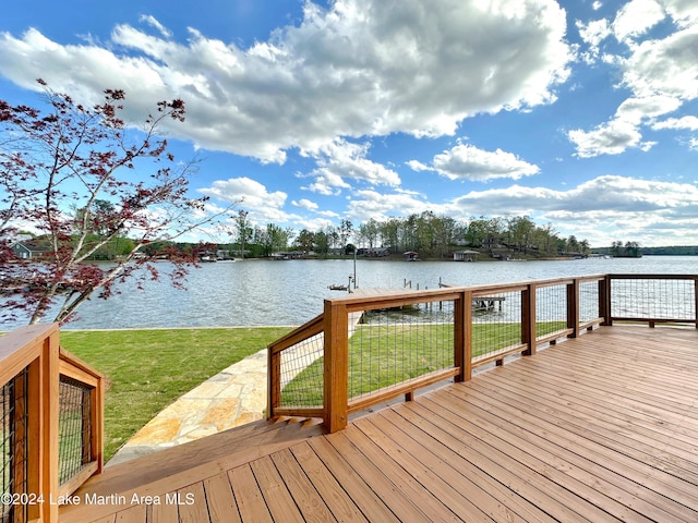 dock area with a water view and a yard