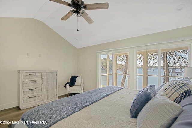 bedroom featuring a water view, vaulted ceiling, ceiling fan, and hardwood / wood-style flooring