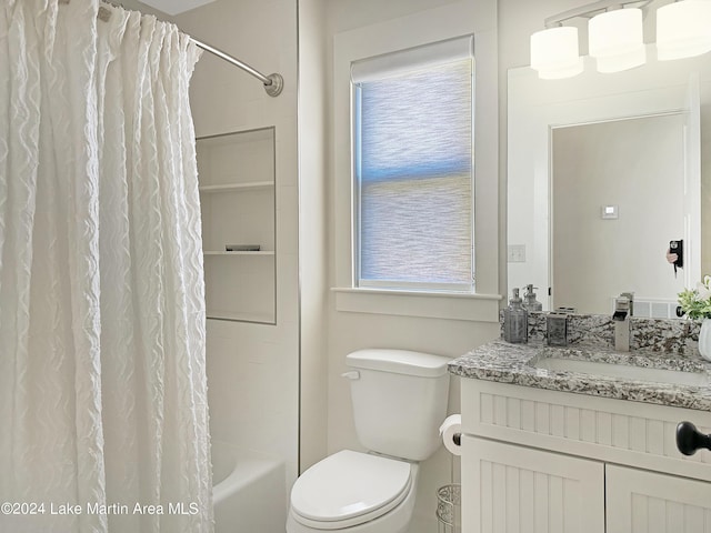 full bathroom featuring shower / tub combo with curtain, vanity, and toilet