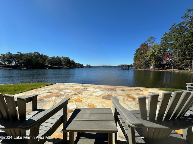 view of dock featuring a patio area and a water view