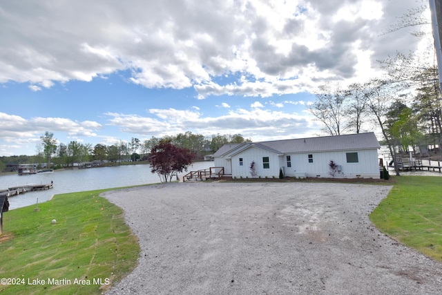 view of front facade with a water view and a front yard